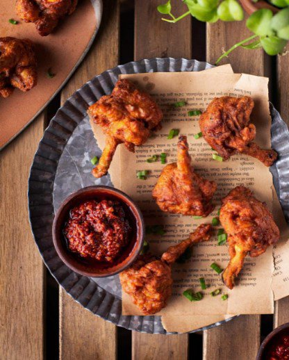 Chicken pieces on a plate with a dip