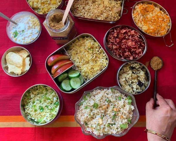 A table with different food items on it like chips, rice etc