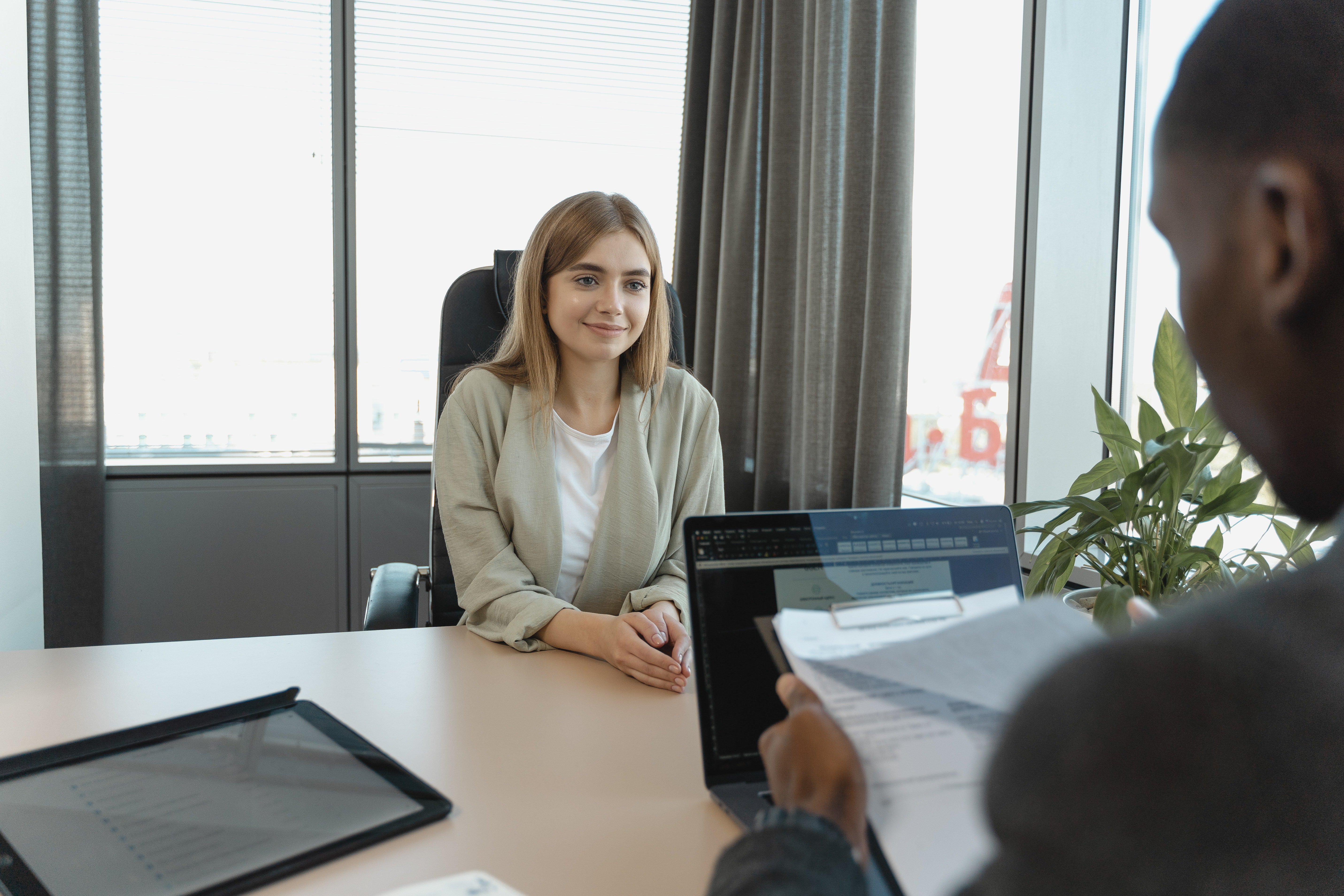 a lady smiling while giving an interview