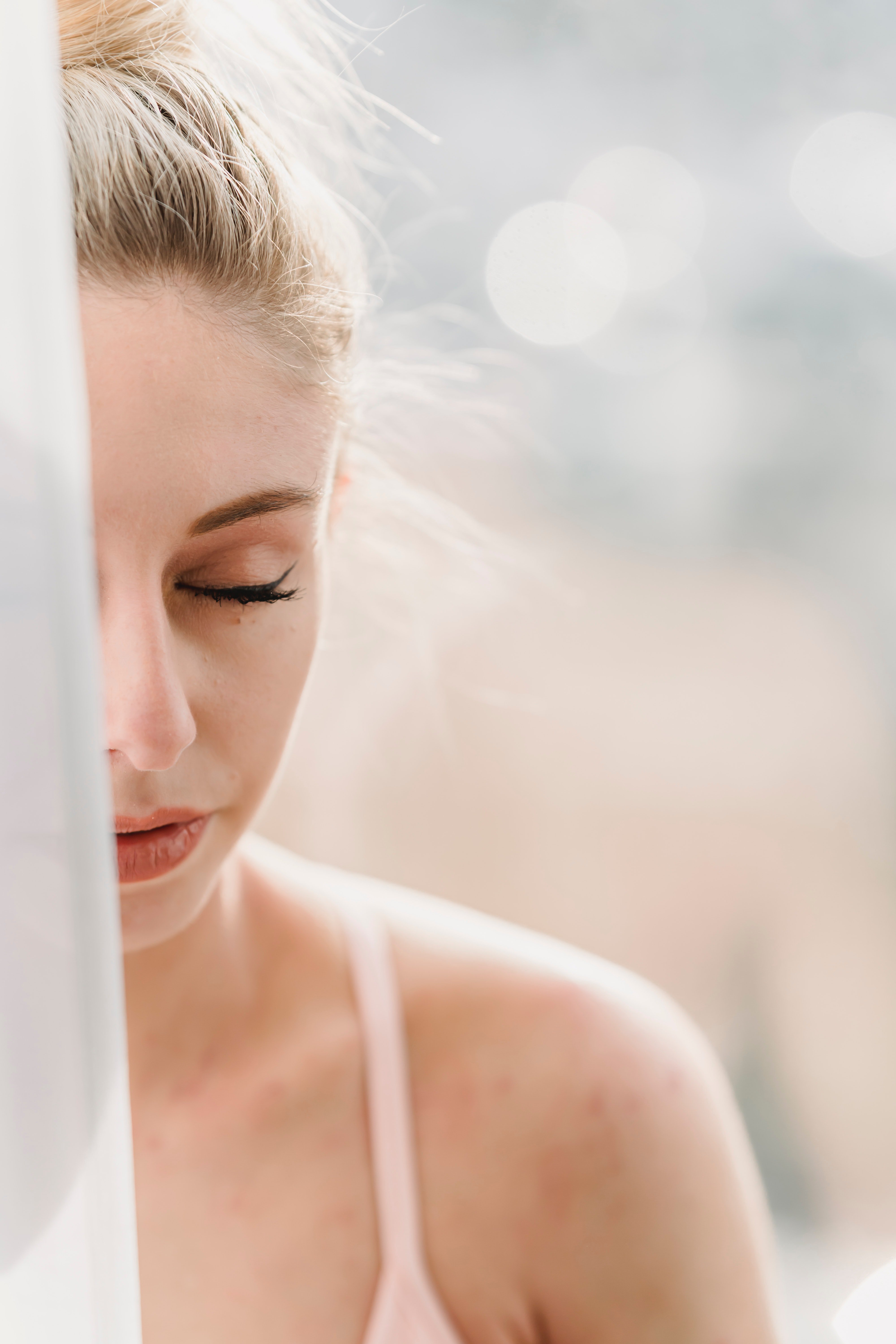 Half face of the girl showing and closing her eyes